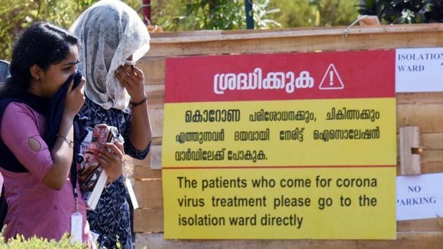 People cover their faces with clothes as they exit from a coronavirus isolated ward at Kochi Medical collage in Kochi.(ANI File Photo)