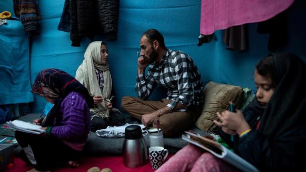 Talibshah Hosini, 35, helps his daughter Farima, 9, with her English vocabulary homework as his two other daughters Parisa, 6, and Marjan, 3, draw pictures inside their temporary shelter at a makeshift camp for refugees and migrants next to the Moria camp, on the island of Lesbos, Greece. Hosini played some tough roles as an actor in Afghanistan before he fled. None was as hard as his real-life fight for survival in a refugee camp on the Greek island of Lesbos. (Alkis Konstantinidis / REUTERS) Talibshah Hosini, 35, helps his daughter Farima, 9, with her English vocabulary homework as his two other daughters Parisa, 6, and Marjan, 3, draw pictures inside their temporary shelter at a makeshift camp for refugees and migrants next to the Moria camp, on the island of Lesbos, Greece. Hosini played some tough roles as an actor in Afghanistan before he fled. None was as hard as his real-life fight for survival in a refugee camp on the Greek island of Lesbos. (Alkis Konstantinidis / REUTERS)