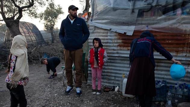 The Hosini family stand outside a temporary shelter. Forced to flee after receiving threats for staging satires at his theatre company that focused on the hardline Islamist Taliban movement, his journey with his wife and three daughters took them to Iran, then to Turkey and eventually Greece. (Alkis Konstantinidis / REUTERS) The Hosini family stand outside a temporary shelter. Forced to flee after receiving threats for staging satires at his theatre company that focused on the hardline Islamist Taliban movement, his journey with his wife and three daughters took them to Iran, then to Turkey and eventually Greece. (Alkis Konstantinidis / REUTERS)