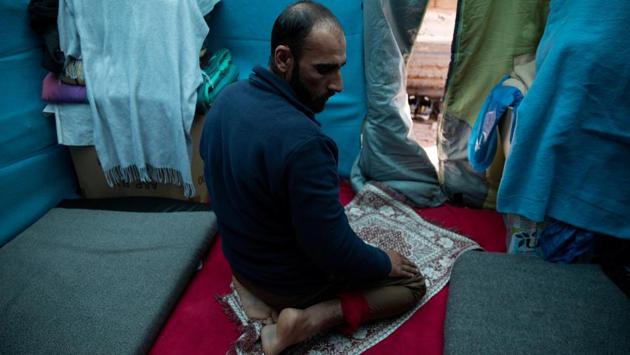 Hosini prays inside a temporary shelter. “We have seen things that should not be spoken of. I myself can’t sleep at night, just in case someone walks into the tent with a knife and stabs me, god forbid, (or) does something awful to my wife,” Hosini said. “I don’t trust anyone, not even our neighbours, because they change all the time.” (Alkis Konstantinidis / REUTERS) Hosini prays inside a temporary shelter. “We have seen things that should not be spoken of. I myself can’t sleep at night, just in case someone walks into the tent with a knife and stabs me, god forbid, (or) does something awful to my wife,” Hosini said. “I don’t trust anyone, not even our neighbours, because they change all the time.” (Alkis Konstantinidis / REUTERS)