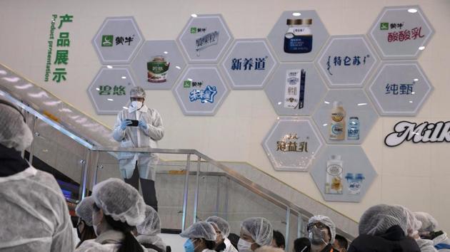 In this Thursday, Feb. 27, 2020, photo, journalists dressed in protective overalls visit the Mengniu dairy factory in Beijing. (AP)