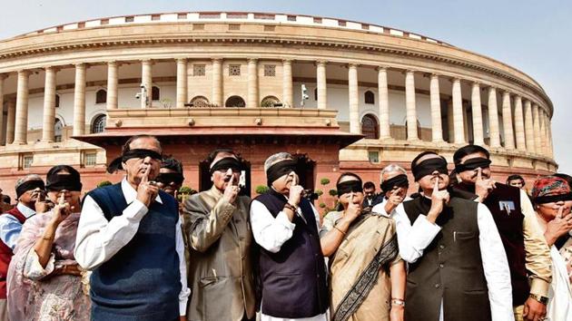 TMC members with black cloths tied over their eyes put fingers on their lips as part of their protest over the recent violence in northeast Delhi, during the second phase of budget session in Parliament, in New Delhi. (Sanjeev Verma / Hindustan Times) TMC members with black cloths tied over their eyes put fingers on their lips as part of their protest over the recent violence in northeast Delhi, during the second phase of budget session in Parliament, in New Delhi. (Sanjeev Verma / Hindustan Times)