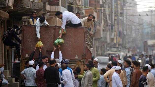 Food supplies are distributed after Friday prayers at Shiv Puri on February 28. (Amal KS / HT Photo)