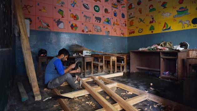 A carpenter works inside the DRP convent school that was damaged in the violence at Shiv Vihar on March 2. (Sanchit Khanna / HT Photo)