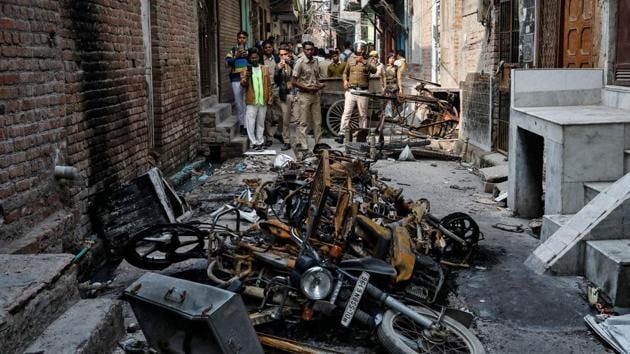Police photograph burnt out properties owned by Muslims in a riot affected area following clashes between people demonstrating for and against a new citizenship law in New Delhi. (REUTERS) Police photograph burnt out properties owned by Muslims in a riot affected area following clashes between people demonstrating for and against a new citizenship law in New Delhi. (REUTERS)