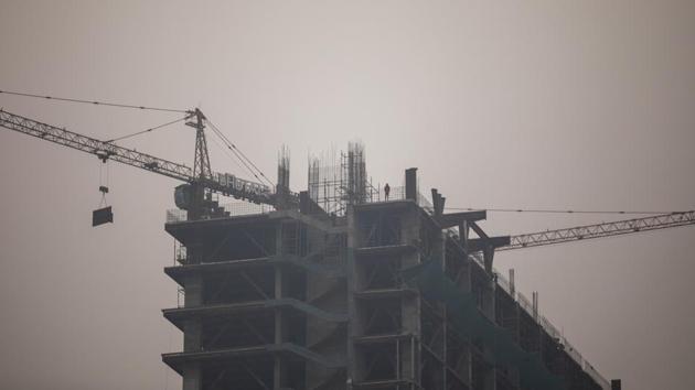 Cranes operate at a Bhutani Group property development in Noida. (Bloomberg) Cranes operate at a Bhutani Group property development in Noida. (Bloomberg)