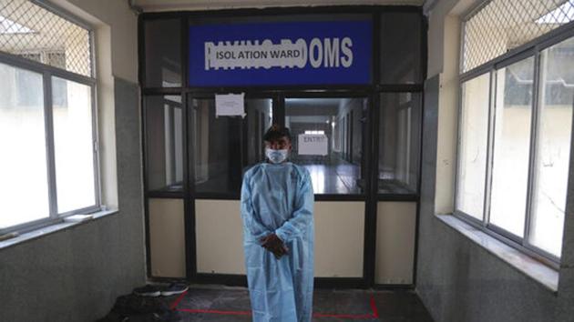 A security man stands in front of an isolation ward where people who returned from China are under observation at the Government Gandhi Hospital in Hyderabad, India. Image used for representational purpose only. (AP) A security man stands in front of an isolation ward where people who returned from China are under observation at the Government Gandhi Hospital in Hyderabad, India. Image used for representational purpose only. (AP)
