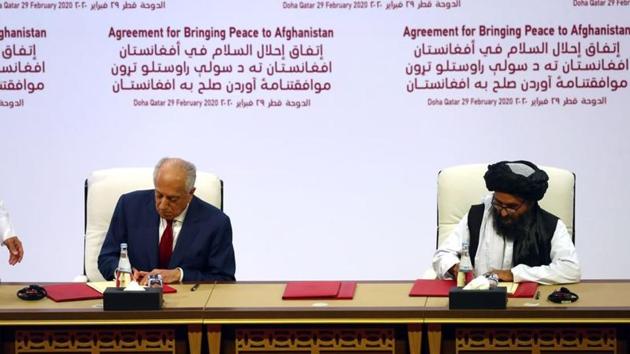 Mullah Abdul Ghani Baradar, the leader of the Taliban delegation, signs an agreement with Zalmay Khalilzad, US envoy for peace in Afghanistan, at a signing agreement ceremony between members of Afghanistan's Taliban and the US in Doha, Qatar.(REUTERS) Mullah Abdul Ghani Baradar, the leader of the Taliban delegation, signs an agreement with Zalmay Khalilzad, US envoy for peace in Afghanistan, at a signing agreement ceremony between members of Afghanistan's Taliban and the US in Doha, Qatar.(REUTERS)