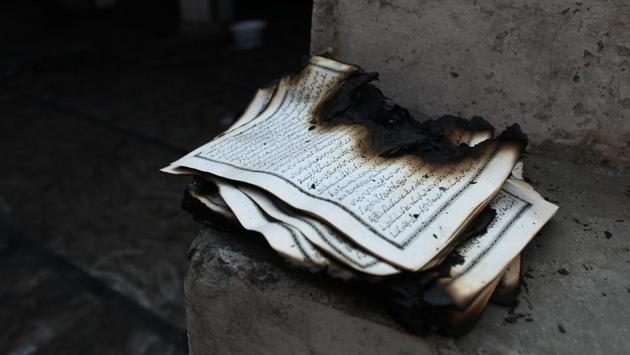 A burnt book found inside a mosque that was gutted in the fire at Brijpuri, Mustafabad on February 26. (Biplov Bhuyan / HT Photo)