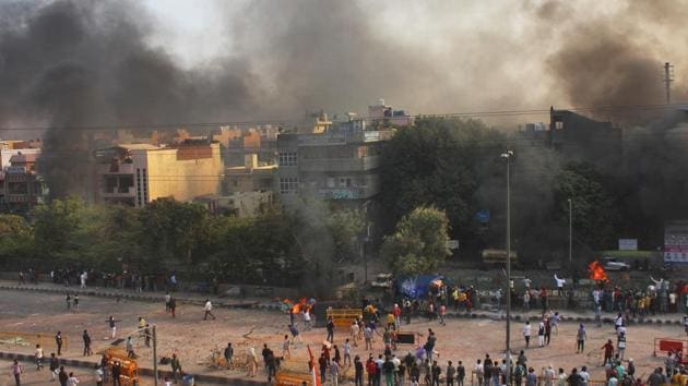 Smoke bellows out of houses that were set on fire during clashes at Yamuna Vihar on Monday, February 24. Curfew was imposed in Maujpur, Jafrabad, Chand Bagh and Karawal Nagar areas immediately after the violence. (Md Meharban / HT Photo)