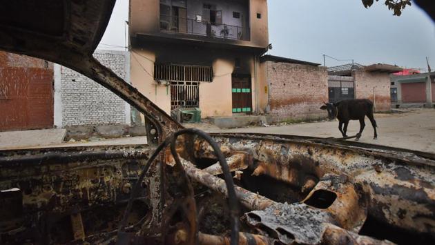 Charred remains of a vehicle are seen outside a house in Old Garhi Mendu village in Shahdara, following communal violence over the new citizenship law. In Delhi, at least 47 people have been killed so far, while more than 350 people have been injured in the communal riots that ravaged the capital from February 23 to 25. (Amal KS / HT Photo)