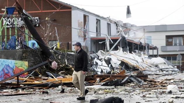 A man walks past storm debris following a deadly tornado in Nashville, Tenn. Tornadoes ripped across Tennessee early Tuesday, shredding buildings and killing multiple people.(AP)