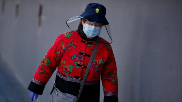 A woman wearing a mask walks in a street in Beijing as the country is hit by an outbreak of the novel coronavirus. (REUTERS) A woman wearing a mask walks in a street in Beijing as the country is hit by an outbreak of the novel coronavirus. (REUTERS)