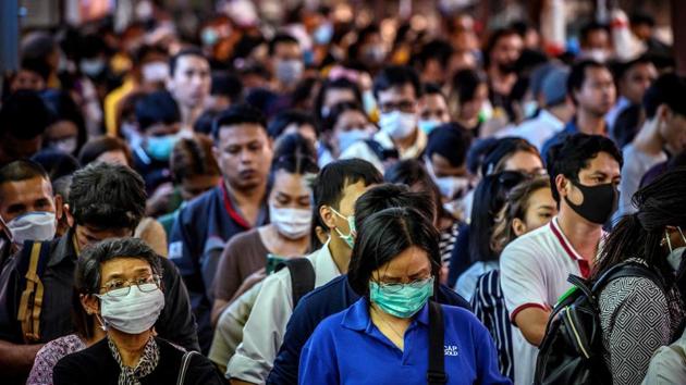 Coronavirus Outbreak Updates: Commuters, wearing facemasks amid fears of the spread of the COVID-19 novel coronavirus, wait for a canal boat in Bangkok on March 2, 2020. - A Thai man has died from complications doctors say were due to the deadly coronavirus, though health officials were reluctant on March 2 to conclusively confirm the cause of his death.(AFP)