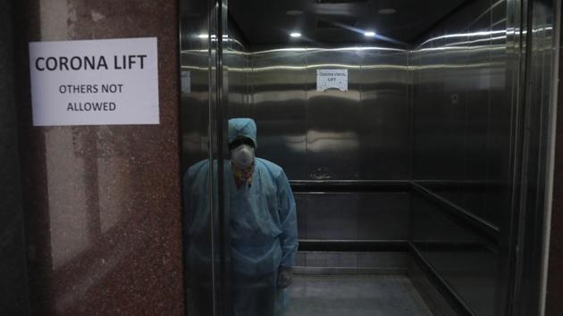 A lift operator stands inside a dedicated lift for people suspected to be infected with the new coronavirus at the Government Gandhi Hospital in Hyderabad. (AP) A lift operator stands inside a dedicated lift for people suspected to be infected with the new coronavirus at the Government Gandhi Hospital in Hyderabad. (AP)