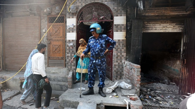 A security personnel at a house in Delhi’s Shiv Vihar which is one of the localities affected by the violence in north-east Delhi.(Raj K Raj / HT Photo)