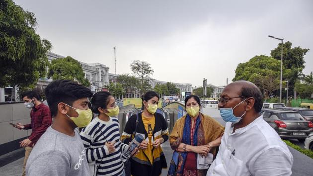 People wearing protective mask following positive cases of Coronavirus in the country, at Connaught Place, in New Delhi on Wednesday. (Burhaan Kinu/HT PHOTO)