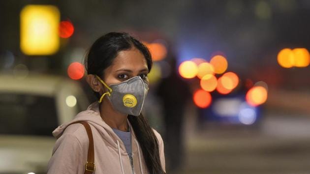 A woman wearing protective mask following few positive cases of Coronavirus, in New Delhi. (Burhaan Kinu/HT PHOTO)