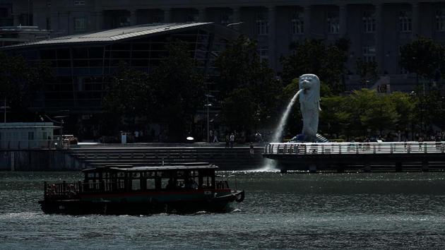 An almost empty tourist bumboat passes a largely empty Merlion Park as tourism takes decline due to the coronavirus outbreak in Singapore.(REUTERS)