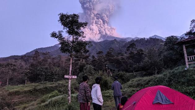Tourists look towards Mount Merapi volcano as it erupts, at Cangkringan district in Sleman, Yogyakarta. Indonesia’s most active volcano erupted Tuesday, shooting a massive ash cloud some 20,000 feet in the air which coated nearby communities with grey dust. (Rizky Tulus / Indonesia Out / REUTERS)