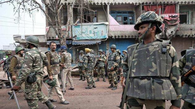 Police stand guard in a riot affected area following clashes in northeast part Delhi(REUTERS)