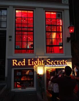 The street-facing windows of the Red Light Secrets museum in Amsterdam.