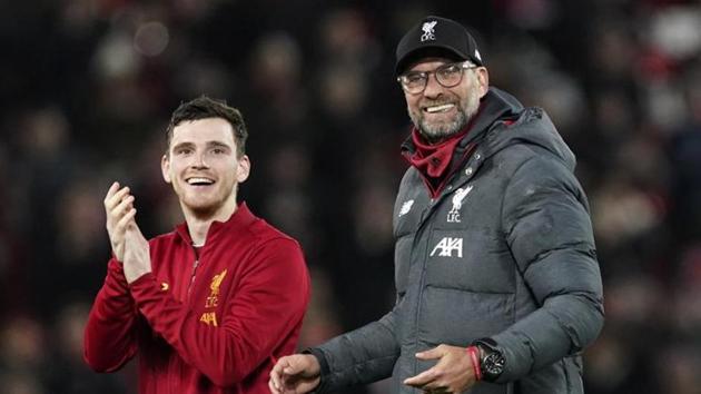 Liverpool's Andrew Robertson, left, and Liverpool's manager Jurgen Klopp greet supporters at the end of the English Premier League soccer match between Liverpool and Sheffield United at Anfield Stadium, Liverpool, England, Thursday, Jan. 2, 2020. (AP Photo/Jon Super)(AP)