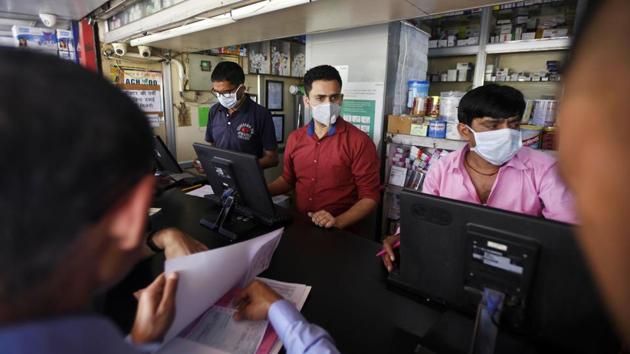 Operators at a medical store are seen wearing protective masks following multiple positive cases of coronavirus in the country, at Safdarjung Hospital, in New Delhi.(Photo: Biplov Bhuyan / Hindustan Times)
