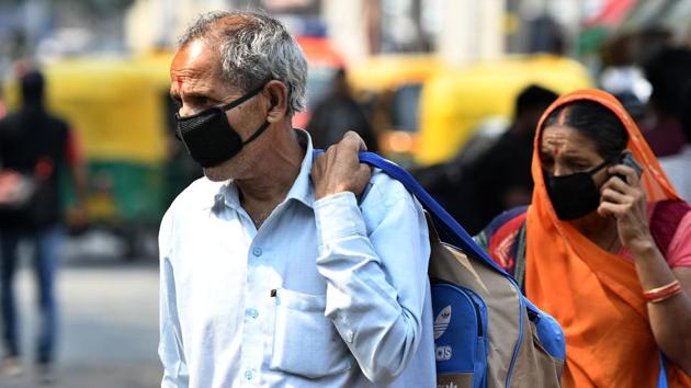 People wearing protective masks following multiple positive cases of coronavirus in the country at Safdarjung Hospital in New Delhi on Wednesday.(Biplov Bhuyan/HT Photo)