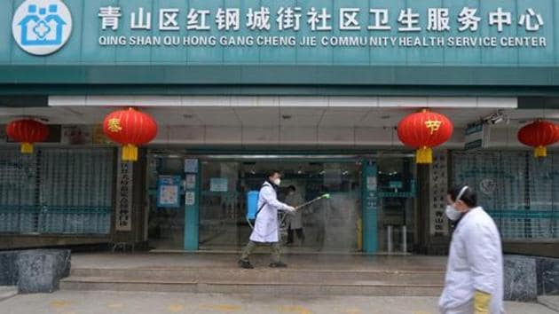 A doctor disinfects the entrance of a community health service center, which has an isolated section to receive patients with mild symptoms caused by the novel coronavirus and suspected patients of the virus, in Qingshan district of Wuhan.(REUTERS)