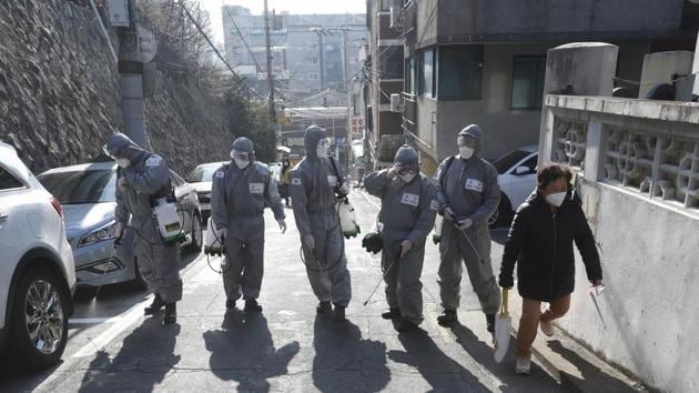 South Korean army soldiers spray disinfectant as a precaution against the coronavirus on a street in Seoul, on Thursday.(AP Photo)