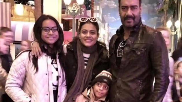 Kajol and Ajay Devgn pose with their kids.(Instagram)