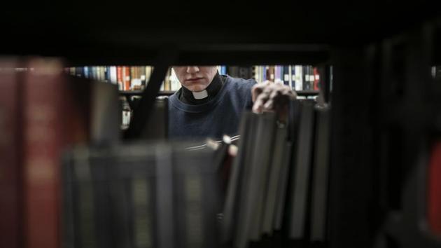 Shane Flanagan returns a book to the shelf in the library at St. Charles Borromeo Seminary. Though the sins of the church may be more muted at this 188-year-old seminary, those preparing to lead Catholicism through its next chapter know they’ll be charged with inspiring those wary of putting trust in the clergy again. (Wong Maye-E / AP) Shane Flanagan returns a book to the shelf in the library at St. Charles Borromeo Seminary. Though the sins of the church may be more muted at this 188-year-old seminary, those preparing to lead Catholicism through its next chapter know they’ll be charged with inspiring those wary of putting trust in the clergy again. (Wong Maye-E / AP)