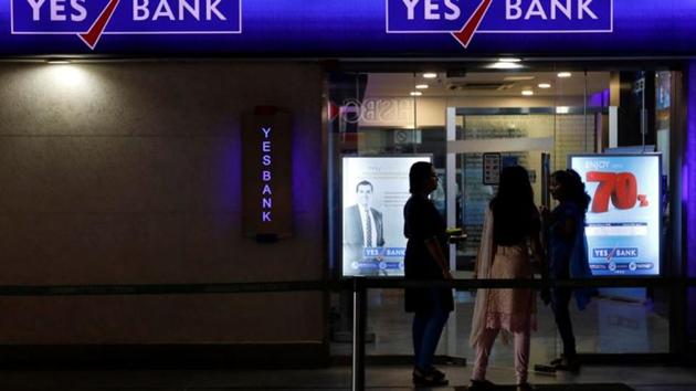 Employees enter a Yes Bank branch at its headquarters in Mumbai.(REUTERS)