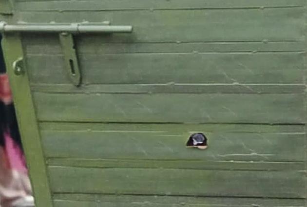 A bullet hole (encircled) in the main gate of the complainant’s house in Balliyewal village in Koomkalan on Friday. (Gurpreet Singh/HT) A bullet hole (encircled) in the main gate of the complainant’s house in Balliyewal village in Koomkalan on Friday. (Gurpreet Singh/HT)