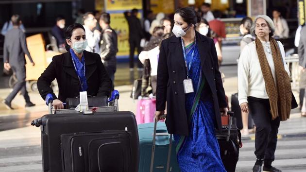 Airport officials seen wearing masks as a preventive measure against the spread of coronavirus at IGI Airport in New Delhi. (VIPIN KUMAR/HT PHOTO.)