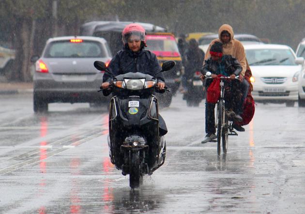 Commuters caught in rain in Mohali on Friday. Commuters caught in rain in Mohali on Friday.