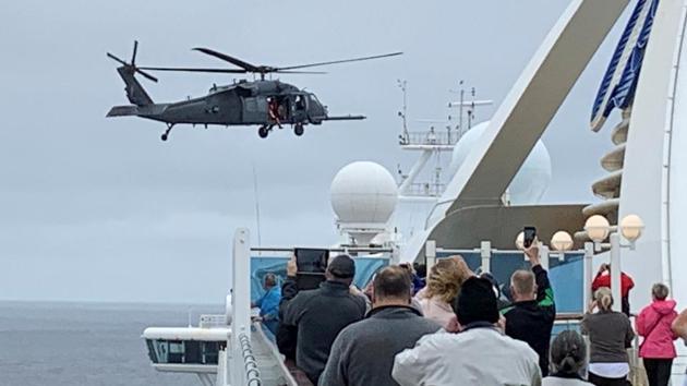 Passengers on board the Grand Princess cruise ship, which had previously carried two passengers who contracted the coronavirus, watch while a U.S. military helicopter hovers above the deck. (Reuters photo) Passengers on board the Grand Princess cruise ship, which had previously carried two passengers who contracted the coronavirus, watch while a U.S. military helicopter hovers above the deck. (Reuters photo)