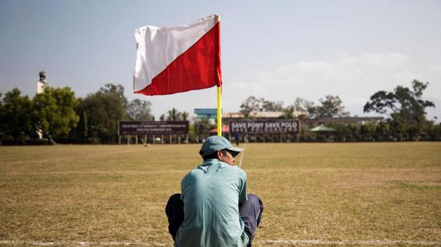 A ground staff places a flag on the field before the start of the 15th Women’s State Polo Tournament. Polo is a rich man’s game in other parts of the world but in Manipur, it is integral to regional traditions and is embraced by all levels of society. (Xavier Galiana / AFP) A ground staff places a flag on the field before the start of the 15th Women’s State Polo Tournament. Polo is a rich man’s game in other parts of the world but in Manipur, it is integral to regional traditions and is embraced by all levels of society. (Xavier Galiana / AFP)