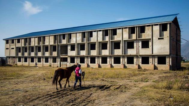 A polo player leads her pony to an open grazing field past an under construction building on the outskirts of Imphal. Laishram Thadoi’s, 35, who is soon wielding her mallet and riding a pony at a full gallop, is among a group of women players challenging the rural region’s all-male traditions in the sport. “If men can play polo why can’t we do it too?” Thadoi told AFP. (Xavier Galiana / AFP) A polo player leads her pony to an open grazing field past an under construction building on the outskirts of Imphal. Laishram Thadoi’s, 35, who is soon wielding her mallet and riding a pony at a full gallop, is among a group of women players challenging the rural region’s all-male traditions in the sport. “If men can play polo why can’t we do it too?” Thadoi told AFP. (Xavier Galiana / AFP)
