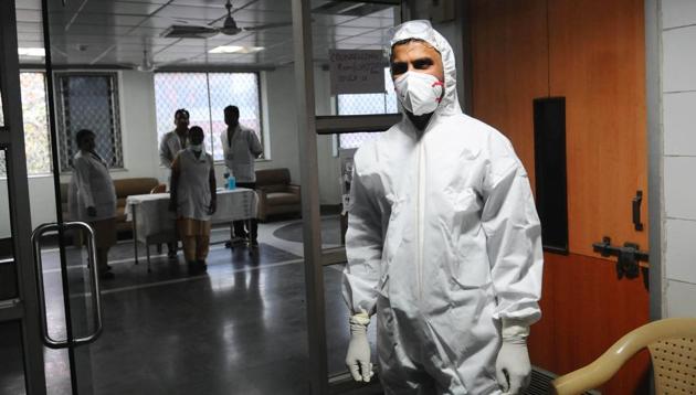 Medical staff with protective clothing seen inside a ward specialised in receiving any person who may have been infected with coronavirus, at Lok Nayak Jai Prakash Narayan (LNJP) Hospital, in New Delhi, India.(HT photo)