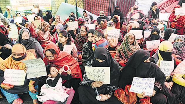 Women and children hold placards during a silent protest against the CAA and the NRC, Shaheen Bagh, New Delhi, February 11(PTI)