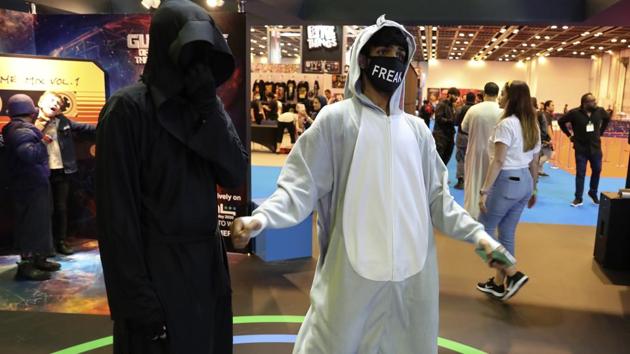 A man dances as he wearing a face mask at the Middle East Comic Con in Dubai, United Arab Emirates, Thursday, March 5, 2020. The Middle East Film & Comic Con has begun in Dubai, a city of skyscrapers and nightclubs suddenly subdued by the outbreak of the new coronavirus across the region. (AP Photo/Kamran Jebreili) (AP)