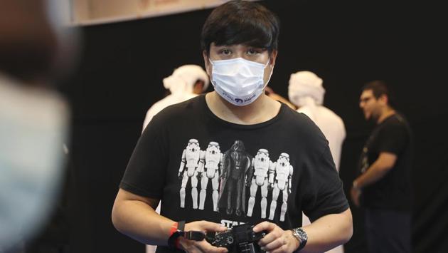 A man wears a mask at the Middle East Comic Con in Dubai, United Arab Emirates, Thursday, March 5, 2020. The Middle East Film & Comic Con has begun in Dubai, a city of skyscrapers and nightclubs suddenly subdued by the outbreak of the new coronavirus across the region. (AP Photo/Kamran Jebreili) (AP)