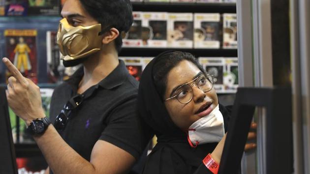 People wear face masks during the Middle East Comic Con in Dubai, United Arab Emirates, Thursday, March 5, 2020. The Middle East Film & Comic Con has begun in Dubai, a city of skyscrapers and nightclubs suddenly subdued by the outbreak of the new coronavirus across the region. (AP Photo/Kamran Jebreili) (AP)