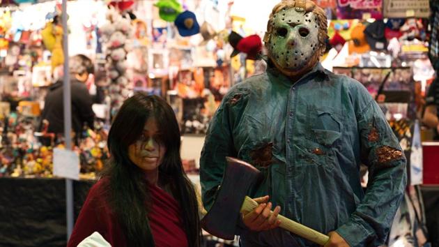 A man dressed as Jason Voorhees from the "Friday the 13th" films stands next to a woman in cosplay at the Middle East Film & Comic Con in Dubai, United Arab Emirates, Thursday, March 5, 2020. The Middle East Film & Comic Con began Thursday night in Dubai, a city of skyscrapers and nightclubs suddenly subdued by the outbreak of the new coronavirus across the region. (AP Photo/Jon Gambrell) (AP)
