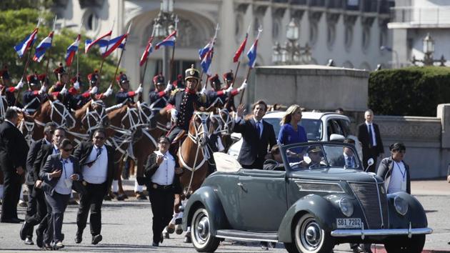 Uruguay's new President Luis Lacalle Pou waves as he rides on an open car with Vice President Beatriz Argimon, after taking the oath of office in Montevideo, Uruguay. (Natacha Pisarenko / AP) Uruguay's new President Luis Lacalle Pou waves as he rides on an open car with Vice President Beatriz Argimon, after taking the oath of office in Montevideo, Uruguay. (Natacha Pisarenko / AP)