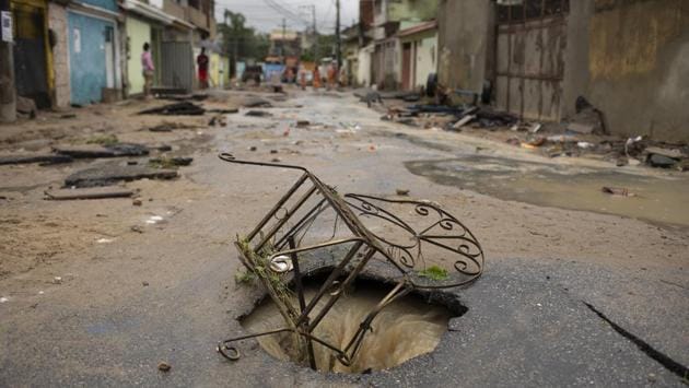 The metal frame of a chair of a is lodged at the mouth of a damaged manhole after heavy rains caused flashfloods in the Realengo neighbourhood of Rio de Janeiro, Brazil. The water flooded the streets and entered homes of residents, with at least 4 deaths reported. (Silvia Izquierdo / AP) The metal frame of a chair of a is lodged at the mouth of a damaged manhole after heavy rains caused flashfloods in the Realengo neighbourhood of Rio de Janeiro, Brazil. The water flooded the streets and entered homes of residents, with at least 4 deaths reported. (Silvia Izquierdo / AP)