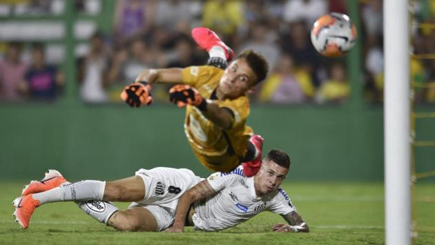 Jobson of Brazil's Santos scores his side's opening goal as goalkeeper Luiz Ezequiel Unsain of Argentina's Defensa Y Justicia fails to stop the ball during a Copa Libertadores Group G soccer match at the Norberto Tomaghello stadium in Buenos Aires, Argentina. (Gustavo Garello / AP) Jobson of Brazil's Santos scores his side's opening goal as goalkeeper Luiz Ezequiel Unsain of Argentina's Defensa Y Justicia fails to stop the ball during a Copa Libertadores Group G soccer match at the Norberto Tomaghello stadium in Buenos Aires, Argentina. (Gustavo Garello / AP)