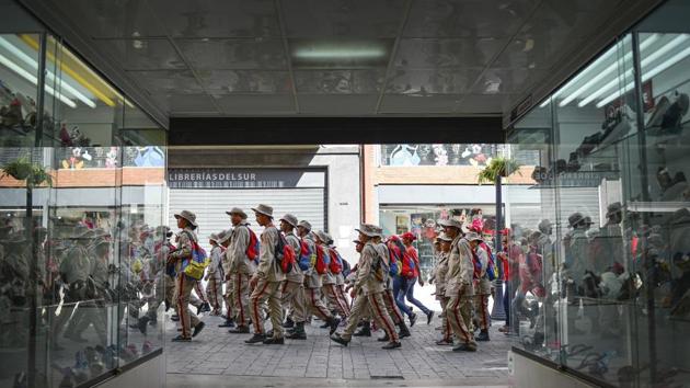 Members of the Bolivarian militia walk after the celebration rally commemorating the 31st anniversary of the 1989 uprising known as the Caracazo, in Caracas, Venezuela. The week-long riots and the protests began mainly in response to the government's economic reforms and the resulting increase in the price of gasoline and transportation. (Matias Delacroix / AP) Members of the Bolivarian militia walk after the celebration rally commemorating the 31st anniversary of the 1989 uprising known as the Caracazo, in Caracas, Venezuela. The week-long riots and the protests began mainly in response to the government's economic reforms and the resulting increase in the price of gasoline and transportation. (Matias Delacroix / AP)